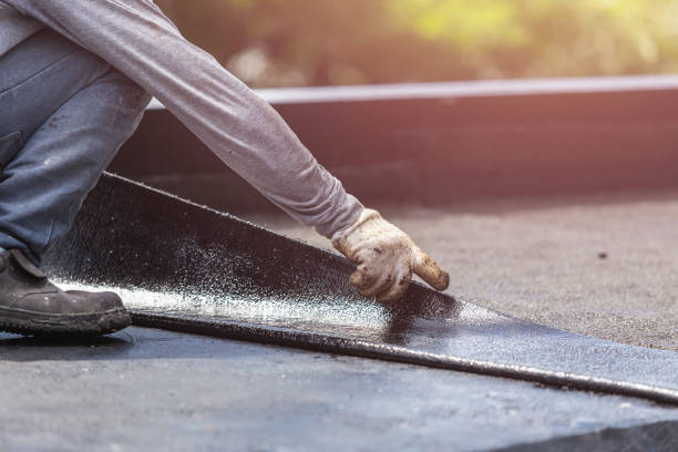 Professional Basement Waterproofing technician working in Lawrence, KS